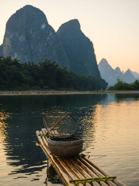istock Wooden bamboo raft in Xingpingm China  at sunset 2163269505