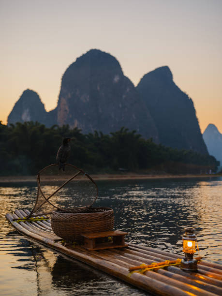 istock Wooden bamboo raft in Xingpingm China  at sunset 2163270110