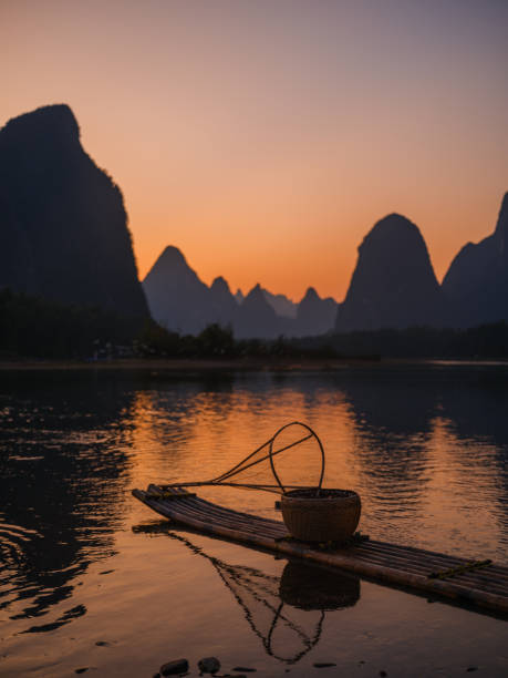 istock Wooden bamboo raft in Xingpingm China  at sunset 2163270292