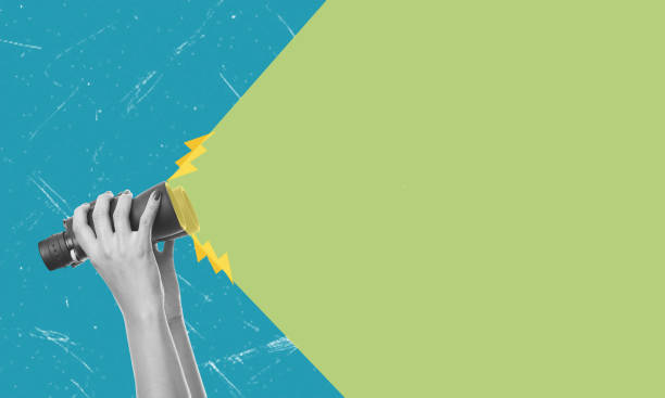 istock Human hand holding binoculars on blue background. 2163271268