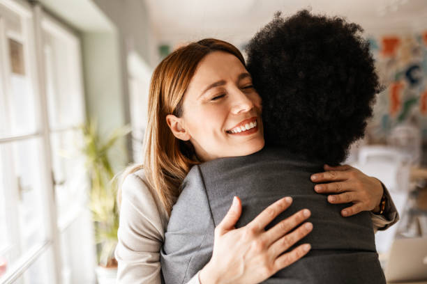 istock Friends Colleagues In Office Hugging 2163274495