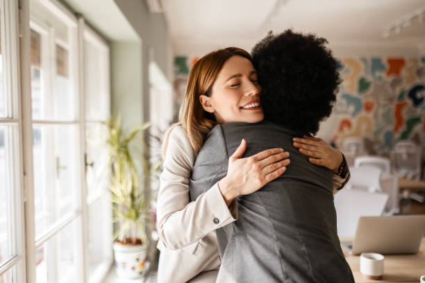 istock Female Friends Colleagues In Office Hugging 2163274544