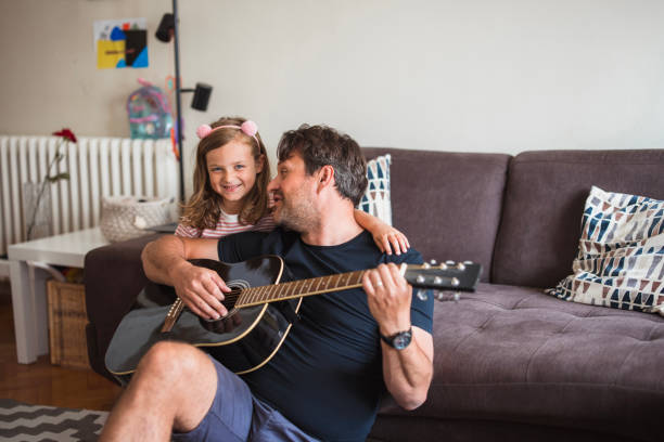 istock Man teaching his daughter to play guitar 2163276944