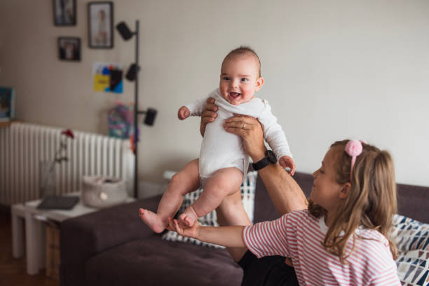 istock Man playing with his daughter and baby son 2163276963
