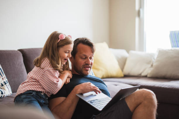 istock Father and daughter using laptop for online shopping 2163277034