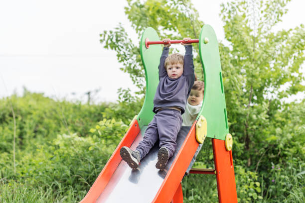 istock Boys Playing on Slide in Green Park 2163280477