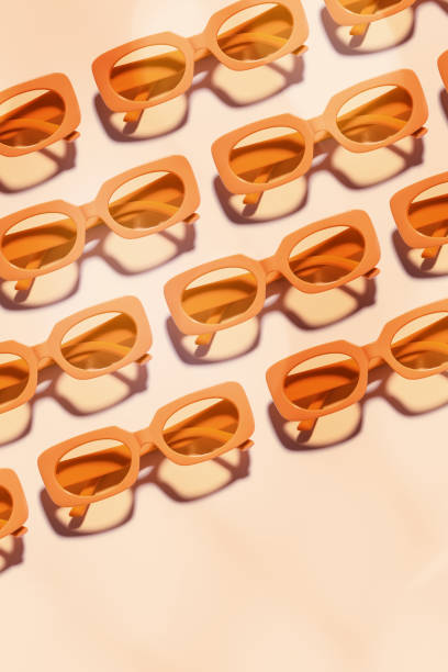 istock Minimal pattern with Stylish sunglasses with Yellow Frame on peach background, sunlight shadow, summer fashion plastic-framed glasses. Aesthetic top view eyeglasses, linear style fashion eyewear 2163281848