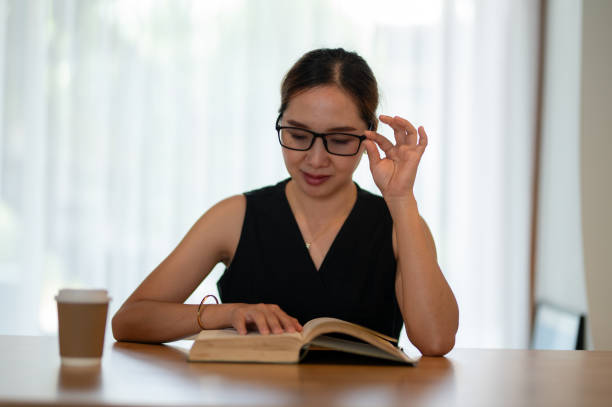 istock Businesswoman Reading Book in Peaceful Office Setting 2163282136