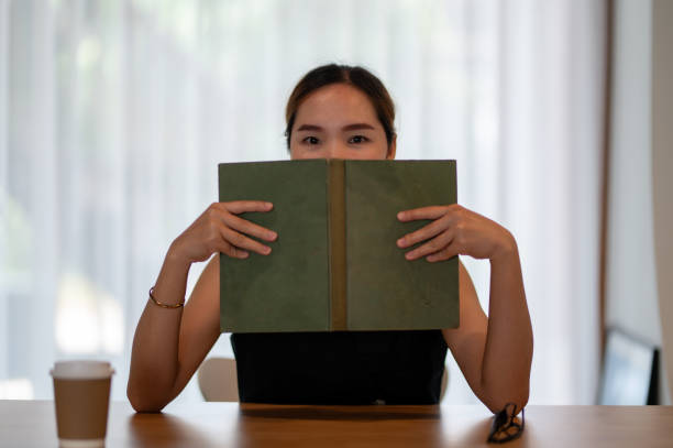 istock Woman Reading Book at Home Office 2163282261