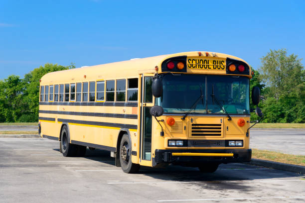 istock Older School Bus Sits Parked For The Summer Vacation 2163282343