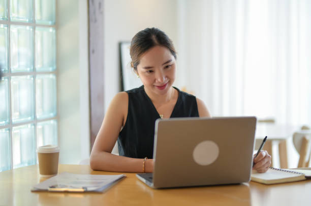 istock Focused Entrepreneur Working on Laptop with Coffee 2163282737
