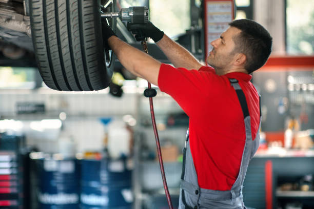 istock Car mechanic replacing a tire, 2163286675