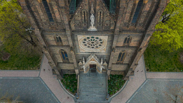 Aerial view of the stunning Saint Ludmila Church located in Vinohrady, Prague. The Neo-Gothic architectural gem stands proudly on Náměstí Míru Square, surrounded by the vibrant cityscape of Prague.
The Basilica of St. Ludmila (Czech: Bazilika svaté Ludmily) is a neo-Gothic Catholic church at Náměstí Míru (Peace Square) in Prague's Vinohrady, built on plans of Josef Mocker in 1888–1892. It is named in honor of St. Ludmila of Bohemia. aerial view of st. peter's basilica ludmila on vinohrady square in prague, st. ludmila's church on namesti miru square, st. peter's basilica in vinohrady quarter on peace square (namesti miru) in the center of prague, basilica of st. ludmila