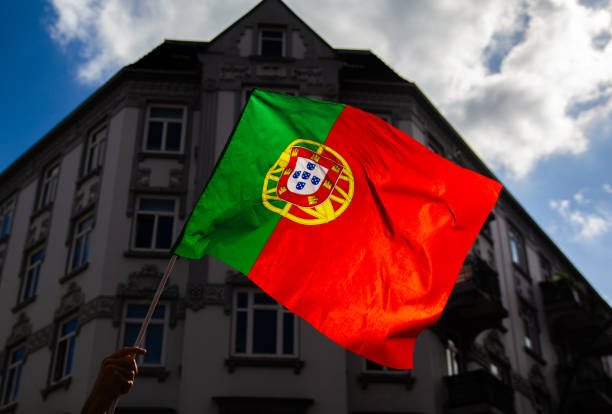 istock Fans Waving Portuguese Flags at Outdoor Event 2163290519