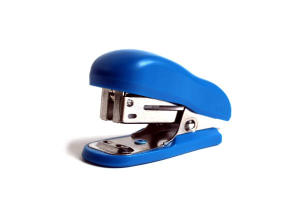 A blue small office stapler is located on a white background.