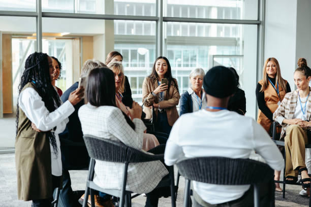 istock Dynamic exchange: Professionals in seminar discussion at modern office 2163291829