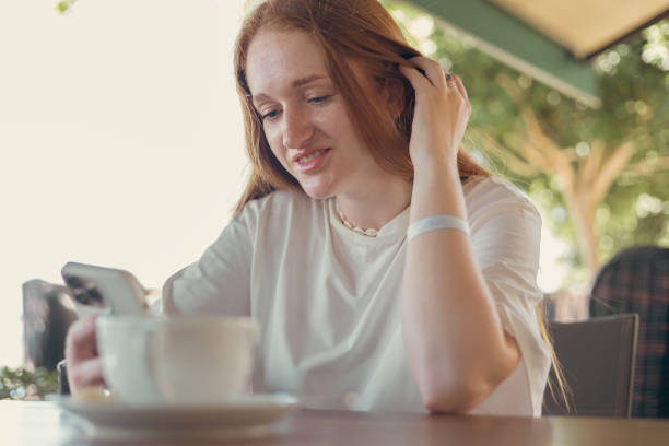 istock Woman in cafe with a smartphone 2163292736