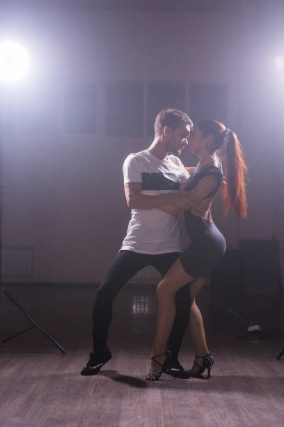 istock Young couple dancing latin dance Bachata, merengue, salsa. Two elegance pose in dance class 2163293057
