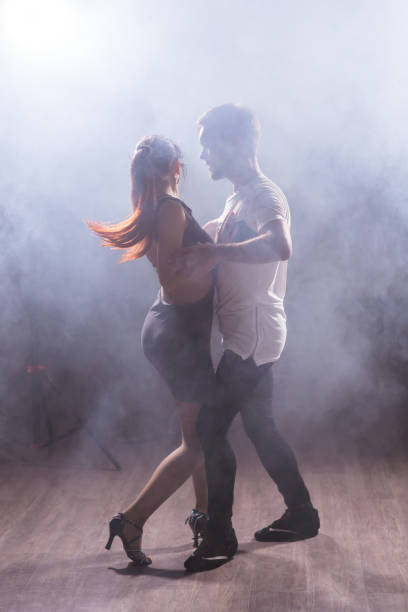 istock Young couple dancing latin dance Bachata, merengue, salsa. Two elegance pose in dance class 2163293146