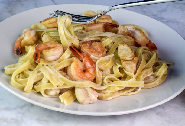 istock shrimp and chicken  fettuccine alfredo 2163295373