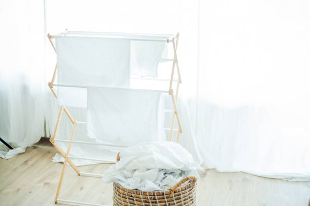 istock Home comfort. Washed light clothes are dried. Basket with clothes 2163295692
