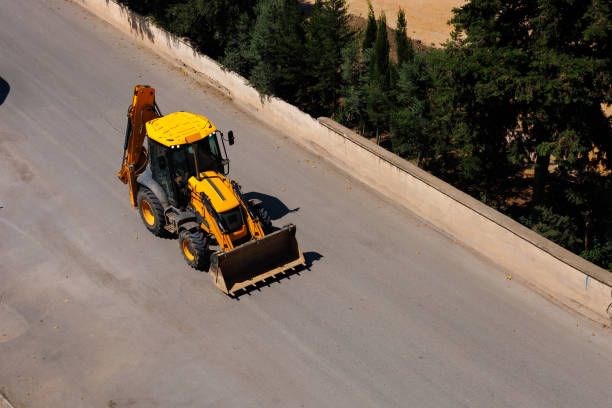 istock An yellow tractor goes on the road 2163297323