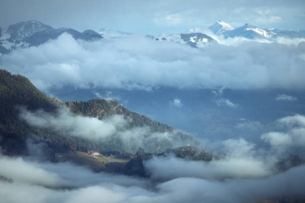 istock A lonely house in the mountains covered with low clouds 2163299497