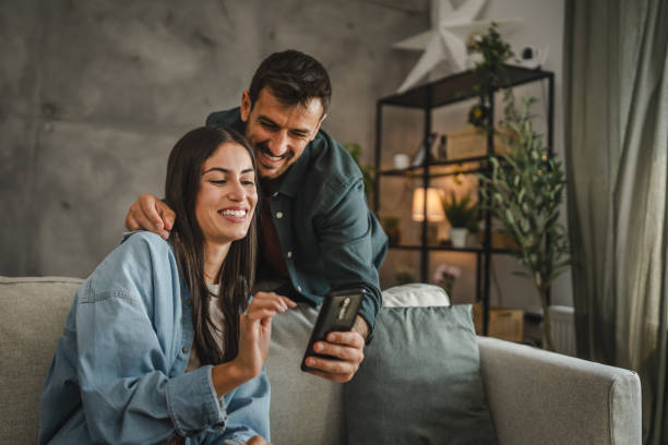 istock Boyfriend show mobile phone screen to his girlfriend while she work 2163300181