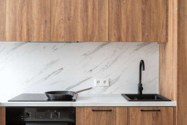 istock Modern kitchen with sink and stove top on white countertop 2163300562