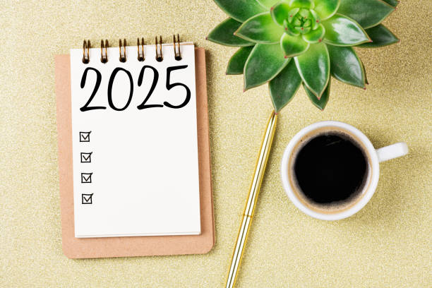 istock New year resolutions 2025 on desk. 2025 goals list with notebook, coffee cup, plant on  table. Resolutions, plan, goals, action, checklist, idea concept. New Year 2025 resolutions, copy space 2163302341