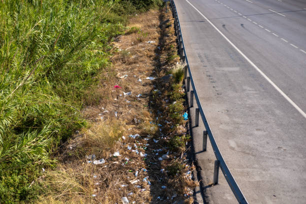 a trash scattered on the sidewalk of the road, outdoor shot