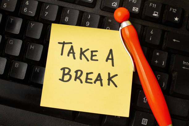 istock A black computer keyboard with a yellow paper note with take a break phrase and a pen on it 2163307927