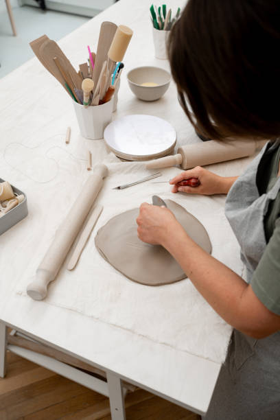 istock Wedging the clay to eliminate air bubbles. Creating perfect homogenous consistence for ceramics handcraft. 2163310481