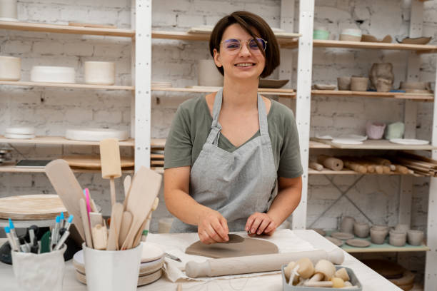 istock Preventing clay bodies from cracks by wedging. Making pliable clay without air pockets. Removing air bubbles from clay before hand building. 2163310486