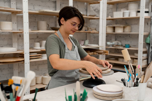 istock Building sides for clay products. Slab pottery. Creating ceramic products from flat sheets of clay. Using hands to model a form for a clay project. 2163310844