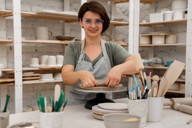 istock Building sides for clay products. Slab pottery. Creating ceramic products from flat sheets of clay. Using hands to model a form for a clay project. 2163310847