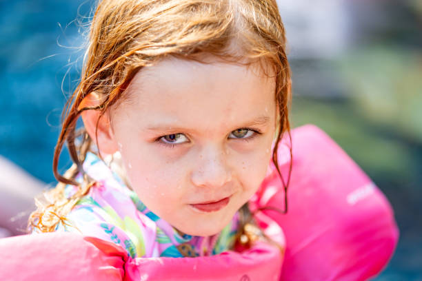 istock Young child being silly while playing in the swimming pool 2163317365