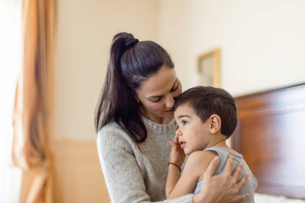 istock Mother Comforting Her Son in Morning Light 2163318738