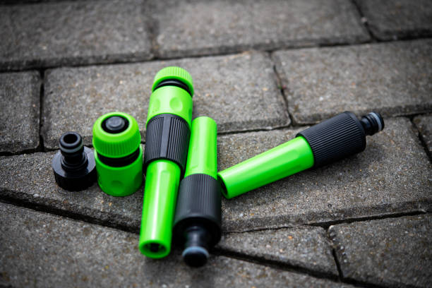 Assorted green and black garden hose connectors provide essential tools for gardeners and landscapers. Ideal for DIY irrigation setups and enhancing garden efficiency with durable materials.