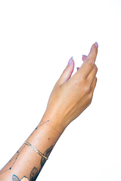 Woman wearing LGBT rainbow bracelet holding Crucifix with Jesus Christ