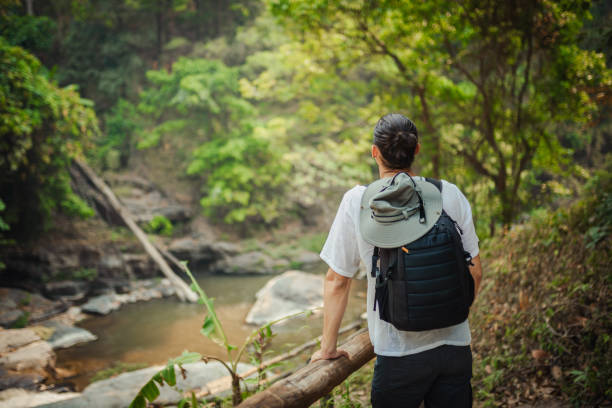 istock Young man exploring the tropical jungle 2163340147