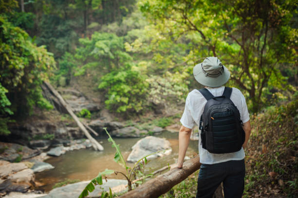 istock Young man exploring the tropical jungle 2163340152