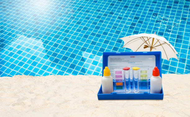 istock Water testing test kit with white umbrella with space on clear swimming pool water background 2163344798