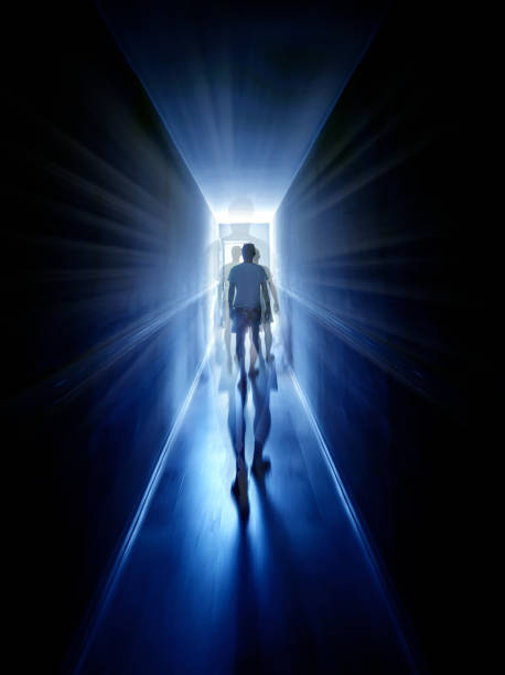 Silhouetted man in narrow corridor of apartment building