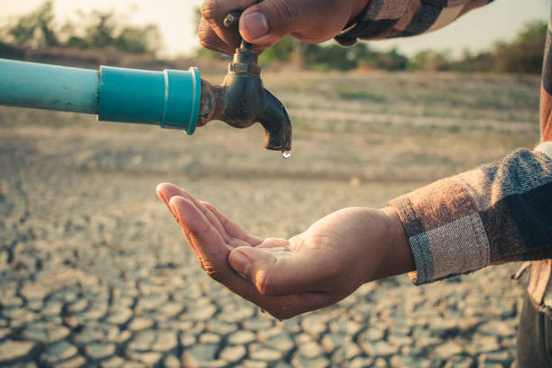 istock Hand for drinking water to live through drought, Concept drought and crisis environment. 2163358217