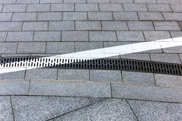 istock white road marking on sewer grate. urban background. closeup view. 2163360475