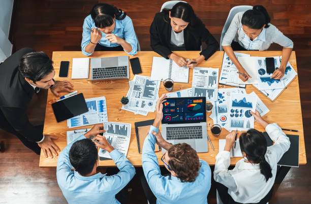 istock Wide top view diverse analyst team analyzing financial data. Habiliment 2163360929