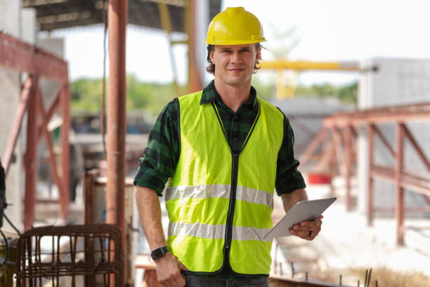 istock Engineer man in hardhat working at construction site, Foreman worker with digital tablet on a construction site 2163362886