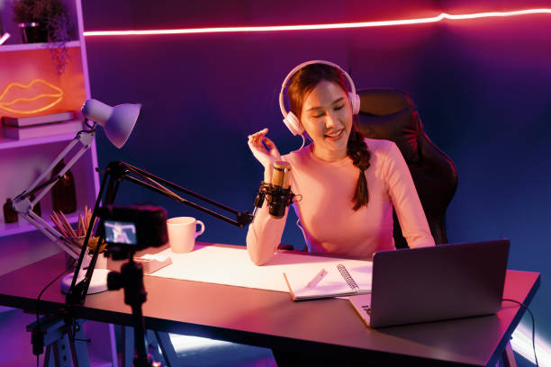 istock Smiling creative young beautiful Asian influencer talking in channel. Stratagem. 2163365025