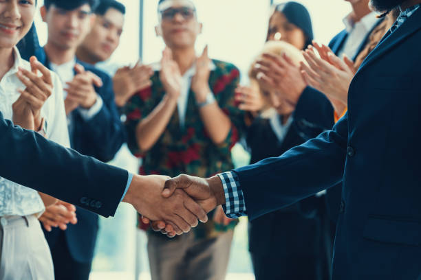 istock Cropped image of smart businessmen shaking hand, making agreement. Intellectual. 2163365319